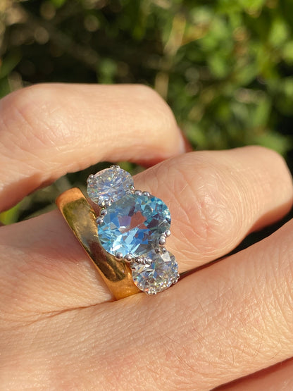 2.57 Carat Blue Topaz and 1.84 Carat Moissanite Three Stone Ring