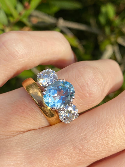 2.57 Carat Blue Topaz and 1.84 Carat Moissanite Three Stone Ring