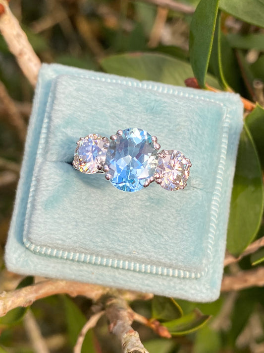 2.57 Carat Blue Topaz and 1.84 Carat Moissanite Three Stone Ring