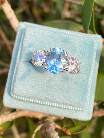 2.57 Carat Blue Topaz and 1.84 Carat Moissanite Three Stone Ring