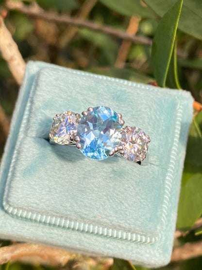 2.57 Carat Blue Topaz and 1.84 Carat Moissanite Three Stone Ring