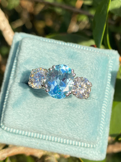 2.57 Carat Blue Topaz and 1.84 Carat Moissanite Three Stone Ring