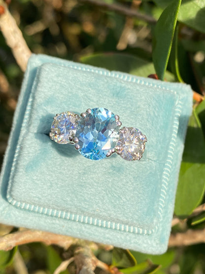 2.57 Carat Blue Topaz and 1.84 Carat Moissanite Three Stone Ring