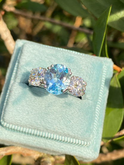 2.57 Carat Blue Topaz and 1.84 Carat Moissanite Three Stone Ring