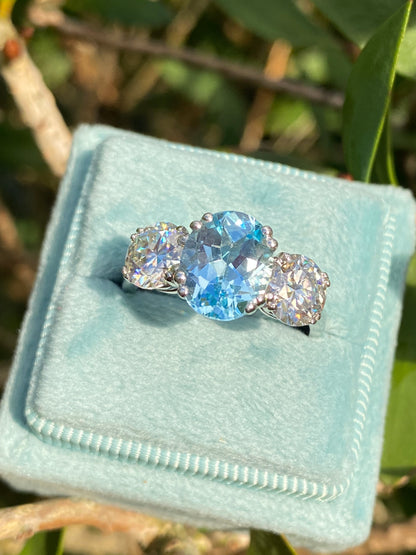 2.57 Carat Blue Topaz and 1.84 Carat Moissanite Three Stone Ring