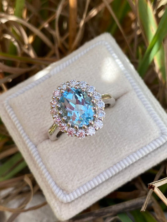 2.33 CTW Oval Cut Blue Topaz and Moissanite Halo Cluster Ring in Sterling Silver