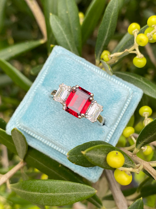 3.50 CTW Emerald Cut Garnet and Moissanite Three Stone Ring in Sterling Silver