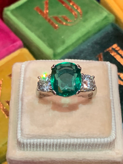 Emerald and diamond three stone ring